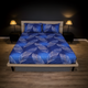 Bed with blue leaf-patterned bedding in a dimly lit bedroom.