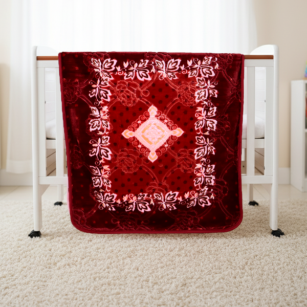 Red prayer mat with intricate patterns on a white stand in a room.