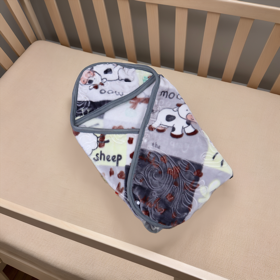 Baby blanket with cartoon sheep design on a crib