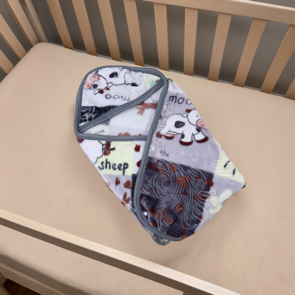 Baby blanket with cartoon sheep design on a crib