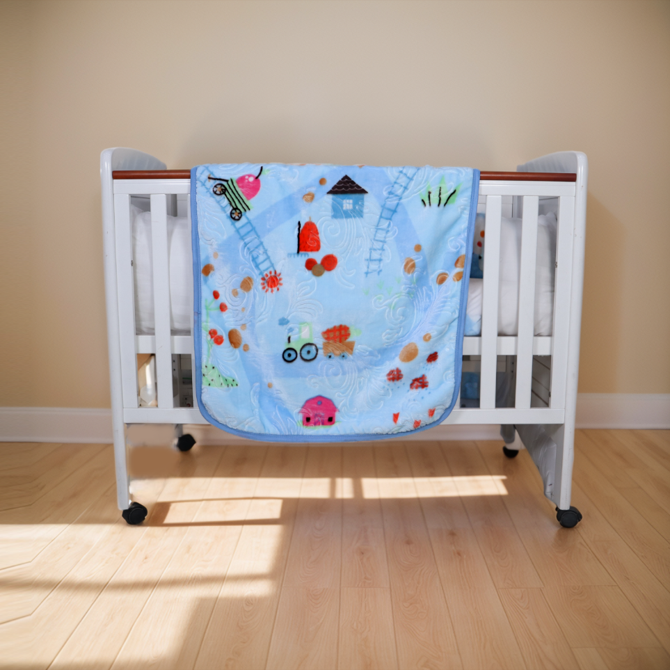 Children's crib with a colorful quilt featuring cartoon characters on a wooden floor.