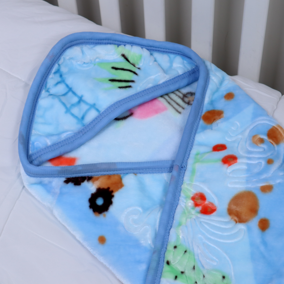 Colorful baby blanket with cartoon design on a white surface