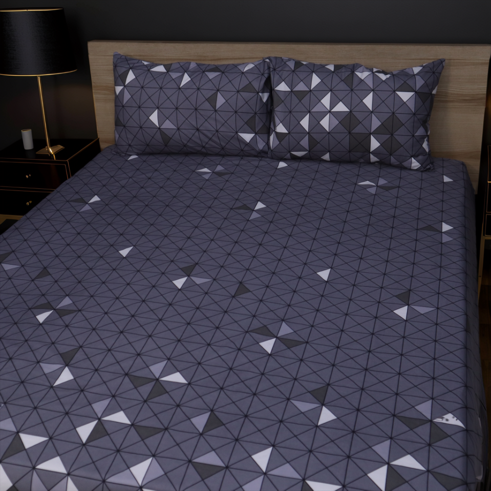 Bed with geometric patterned bedding in a bedroom setting