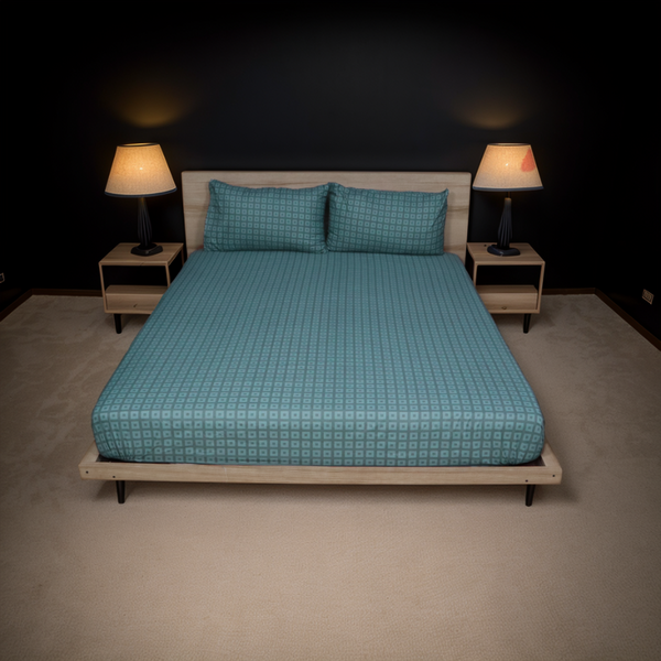 Bed with blue checkered bedding in a dimly lit room with two lamps.