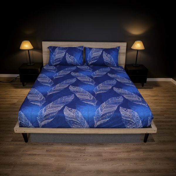 Bed with blue leaf-patterned bedding in a dimly lit bedroom.