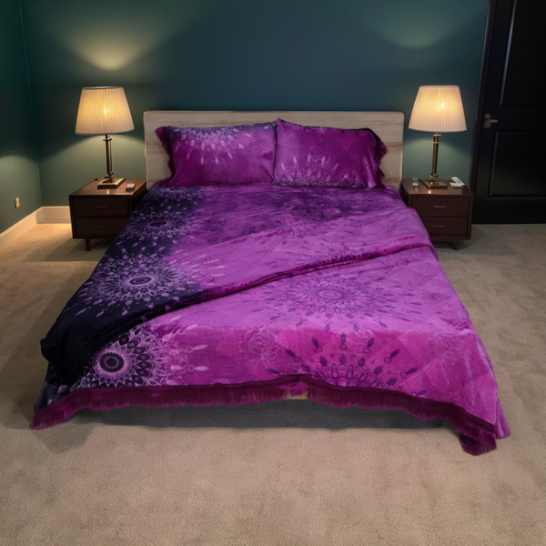 Bedroom with purple bedding and two lamps on nightstands.