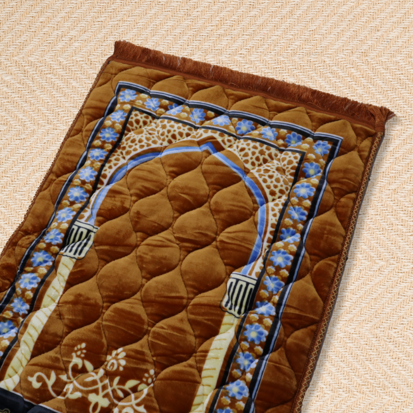 Brown prayer mat with intricate patterns on a beige surface