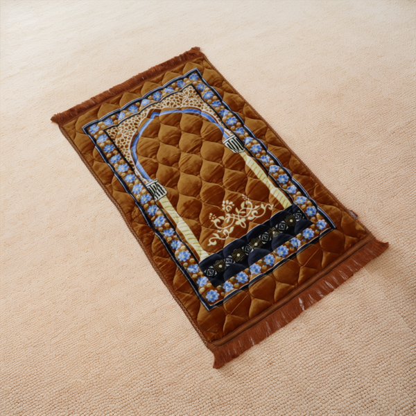 Decorative prayer mat with intricate design on a beige surface