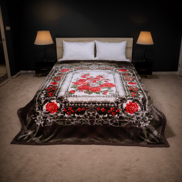 Decorative floral quilt on a bed in a bedroom with lamps and dark walls.