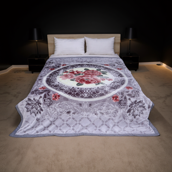 Floral patterned quilt on a bed in a dimly lit bedroom