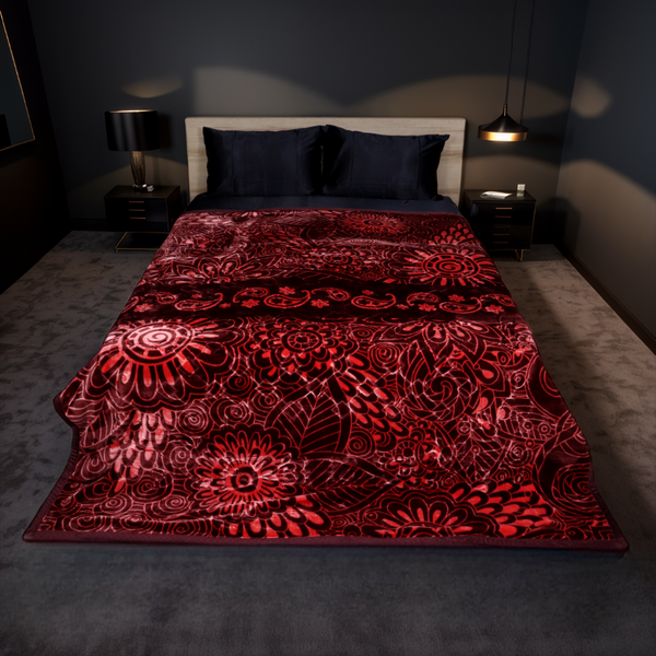Red patterned blanket on a bed in a dimly lit bedroom