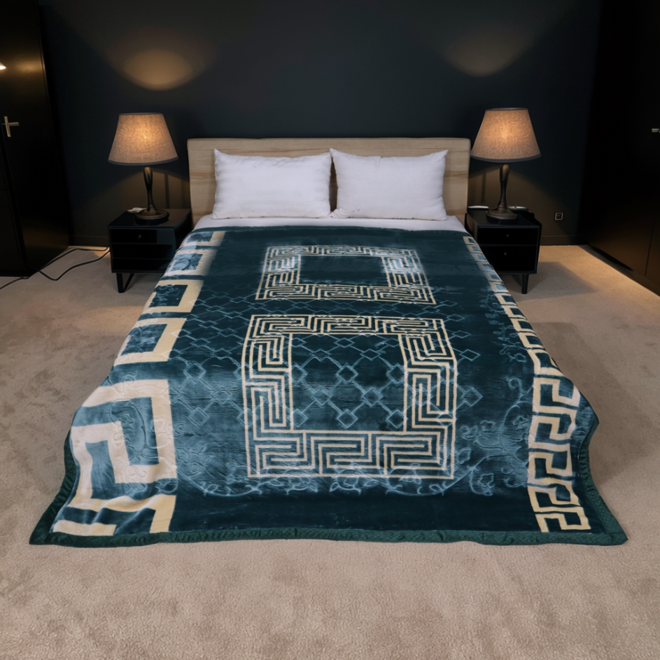 Bed with a blue patterned comforter in a dimly lit bedroom.