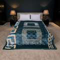 Bed with a blue patterned comforter in a dimly lit bedroom.