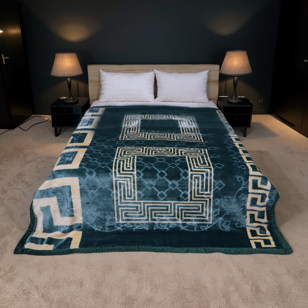 Bed with a blue patterned comforter in a dimly lit bedroom.