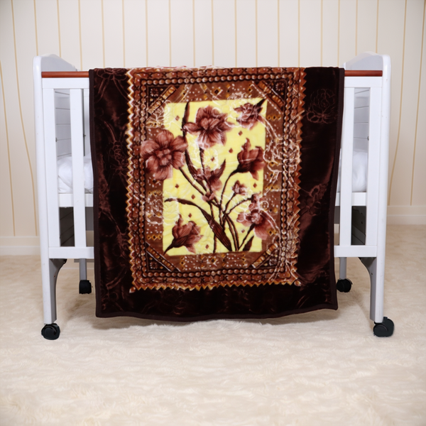 Floral-patterned blanket draped over a crib with a white background