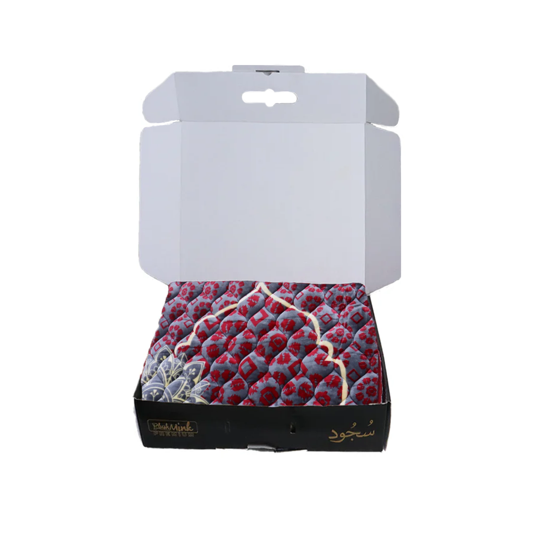 Open box containing a patterned fabric with visible branding on a white background perfect for gifting in Pakistan 