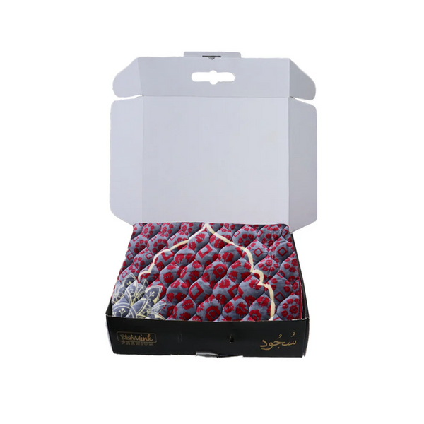 Open box containing a patterned fabric with visible branding on a white background perfect for gifting in Pakistan 