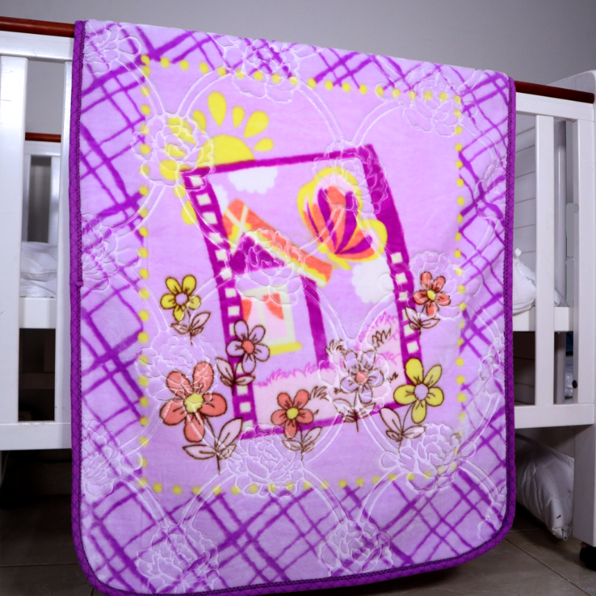Purple quilt with floral and butterfly designs on a crib